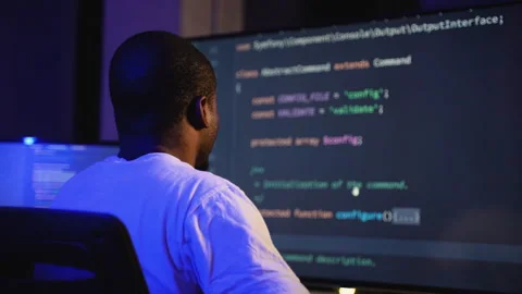 African American hacker coding a cyber attack in dark office Stock Footage 305009833