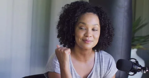 African American hosts reacting to off-camera cue in studio, woman speaking into Stockbeeldmateriaal 340974746