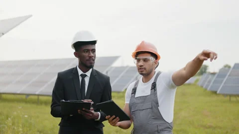 African american inspector with tablet in hands giving instruction to indian Stock Footage 168476027