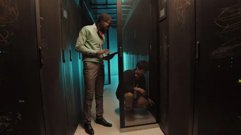 African-American IT Engineer Asking Colleague Question in Data Center 動画素材 149654814