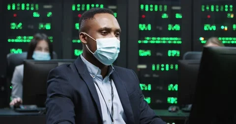 African American IT programer working on desktop computers in data center Stock Footage 144411338