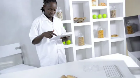 African American lab technician using tablet computer while working Stock Footage 199629299