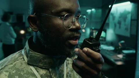 African American Lieutenant Transmitting Coordinates on Radio in Command Center Video stock 296210548