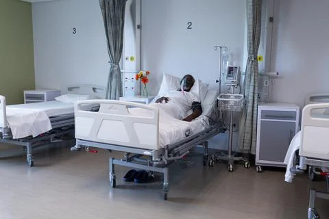 African american male patient lying on hospital bed wearing oxygen mask Stock Photos