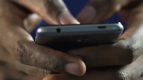 African American male typing fast message on mobile phone, staying in contact Stock Footage