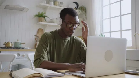 African American male web developer or programmer working at home behind a Stock Footage 219335943