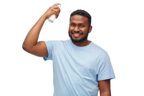 African american man applying hairspray to hair Stock Photos