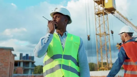 African american man builder engineer worker in hard hat with use a walkie Video stock 139341450