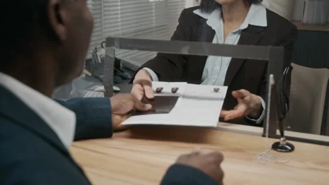 African American Man Checking Documents while Applying for Business Visa Stock Footage 331511618