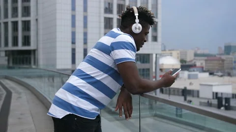 African american man checking mobile app outdoors Stock Footage 96077586