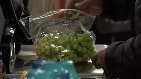 African american man checking out grapes at grocery store self checkout Stock Footage 309293916
