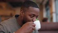 African American Man Drinking Tea Sitting In A Cafe, Slow Motion Stock Footage