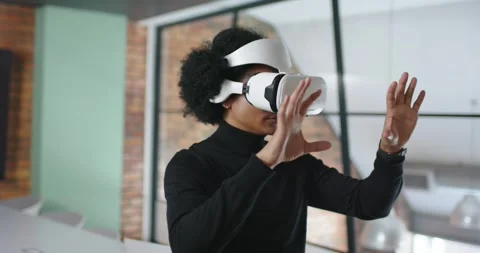 African American man fitting white VR headset raising hands manipulating virtual Stock Footage 341026784
