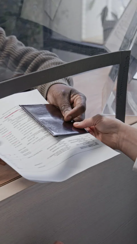 African American Man Handing Documents And Passport To Teller Stock Footage 330966896