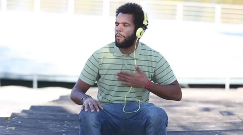 African american man with headphones listening to music Stock Footage 59555493