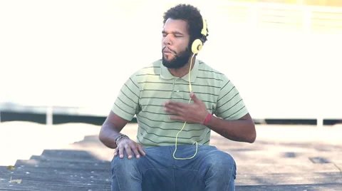 African american man with headphones listening to music Stock Footage 59555500
