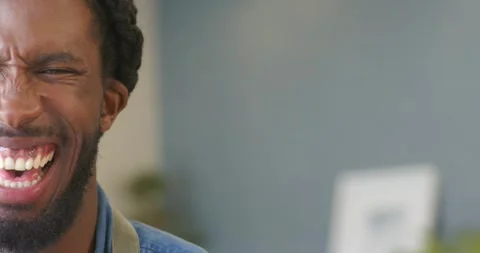 African American man hearing off camera joke bursting into laughter cafe wearing Stock Footage 340454332