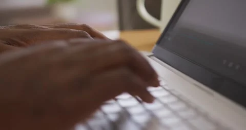 African American man hovering finger then moving hands, tapping keys on laptop Stock Footage 340257631
