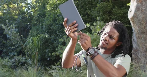 African American man inspecting tip, aligning green cable and inserting plug Stock Footage 343839493