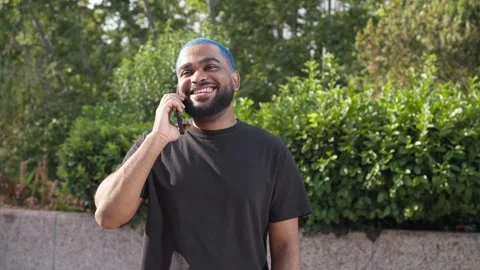 African american man laughing using a smartphone talking to friend.MOV 스톡 동영상 285657573