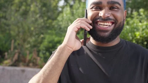 African american man laughing using a smartphone talking to a friend.MOV 库存影片 285657684