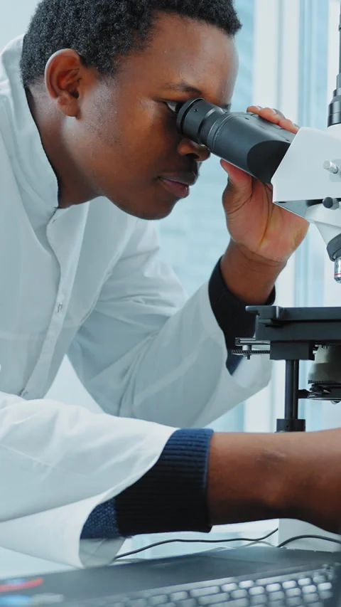 African-American Man Looking In Microscope Stock Footage 269759411