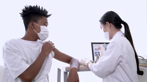 African American man looking at while getting covid vaccine injecting vaccine. Stock Footage 155938112