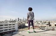 African American Man Overlooking Cityscape From Urban Rooftop Stock Photos