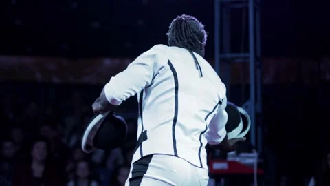 African-American man performs dynamic hat juggling act on stage for live Stock Footage 344847040