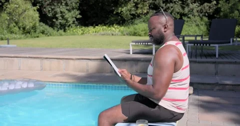 African American man picking up tablet, reading and tapping pages for relaxation Stock Footage 339592074