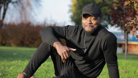 African-American man posing for camera in the park Stock Footage 147952856