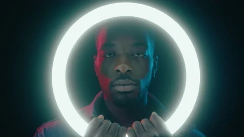 African American Man Posing with Ring Light in Dark Studio Stock Footage 236686651