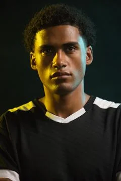 African American man posing in studio under two-tone yellow teal lighting, in Stock Photos