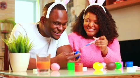 African american man preparing for Easter in apartment Stock Footage 148109988