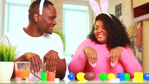 African american man preparing for Easter in apartment Stock Footage 148333835