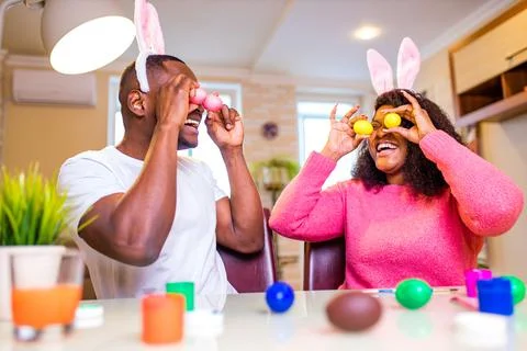 African american man preparing for Easter in apartment Stock Photos