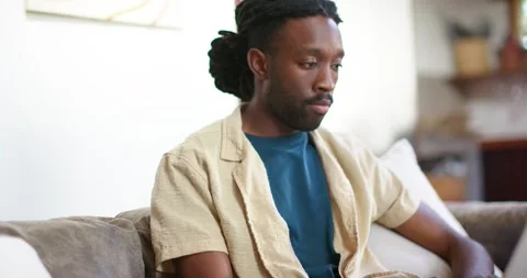 African American man reading screen and typing on laptop for work, pausing, Stock Footage 345124128