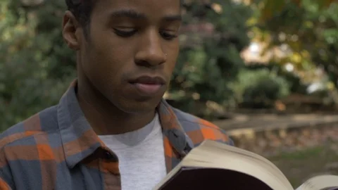 African American Man Reading Scripture and Life Lessons 動画素材 121385472