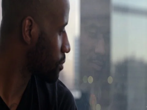 African American man reflected in window overlooking Los Angeles skyline 4K Stock Footage 73241795