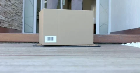 African American man retrieving package from coir doormat, reaching and lifting Stock Footage 344331286