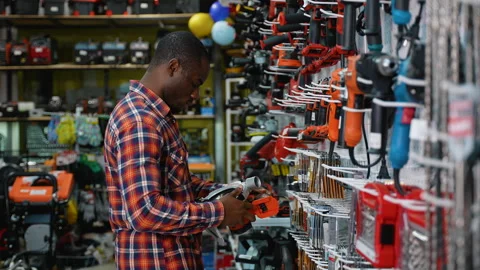 African-American Man Selecting a Circular Saw in a Hardware Store Stock Footage 295968558
