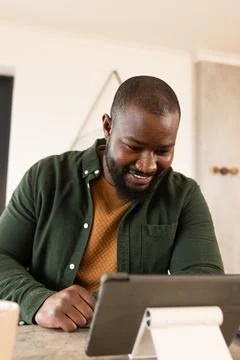 African American man smiling using digital tablet on white stand at stone Stock Photos