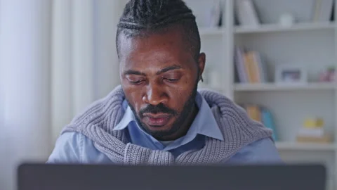 African american man software developer working on laptop at cozy home office Stock Footage 188162279