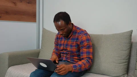 African american man software developer programming codes while working from Stock Footage 268277917