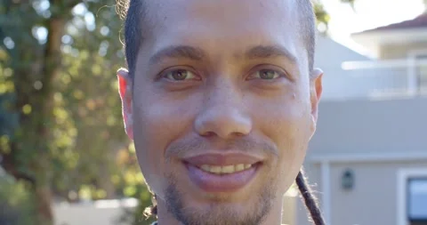African American man standing in front of house smiling at camera, revealing Stock Footage 337160915