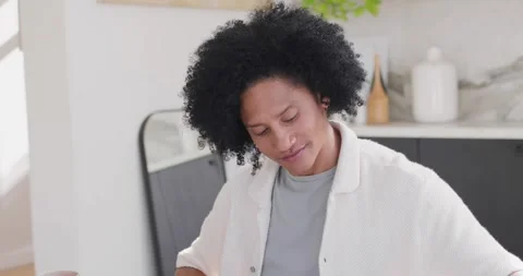African American man starting study at home, flipping papers while checking Stock Footage 337239104