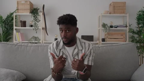 African American man talking to camera sitting on sofa Vidéo 240907943