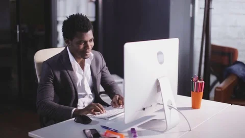 African american man type on keyboard in the modern office Stock Footage 80911057
