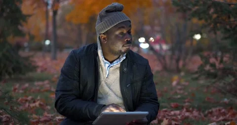 African american man uses tablet computer, thinks and inputs data Stock Footage 202022269