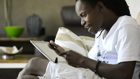 African American man using and viewing tablet computer Stockbeeldmateriaal 199628911
